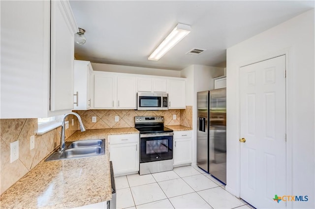 5500 Lions Gate Ln, Killeen, TX 76549 - kitchen featuring appliances with stainless steel finishes, white cabinets, and tasteful backsplash