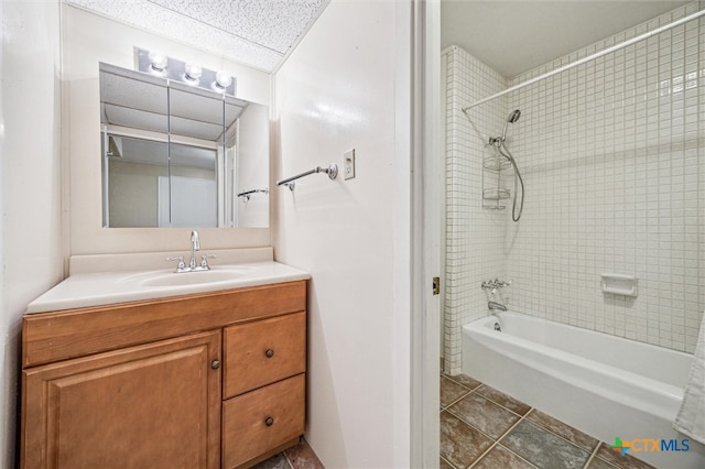 bathroom featuring tile patterned flooring, vanity, shower / bathtub combination, and a paneled ceiling