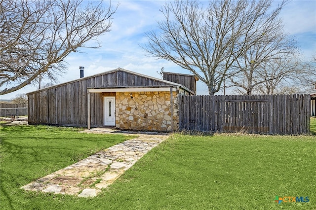 exterior space with an outbuilding and fence