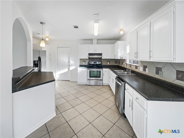 kitchen with white cabinetry, sink, light tile patterned floors, and stainless steel appliances