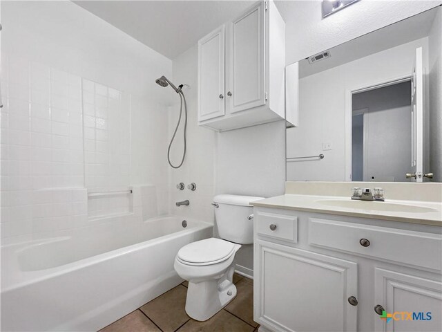 full bathroom featuring tile patterned floors, bathing tub / shower combination, vanity, and toilet