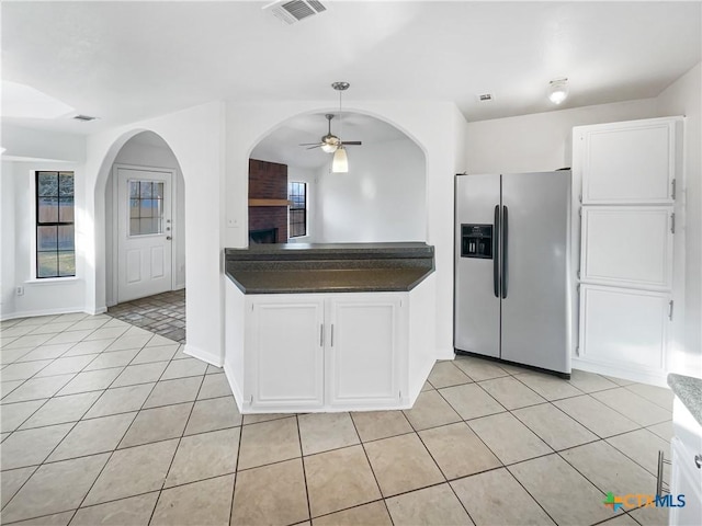 kitchen featuring white cabinetry, ceiling fan, light tile patterned flooring, and stainless steel refrigerator with ice dispenser