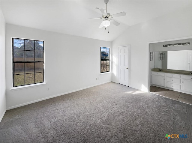 unfurnished bedroom featuring ceiling fan, light carpet, and vaulted ceiling