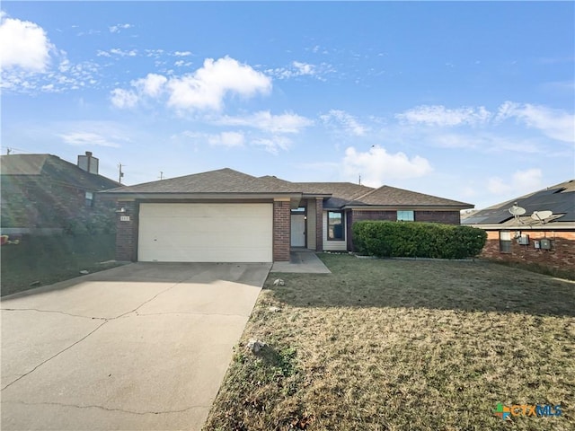 view of front of property featuring a garage and a front lawn