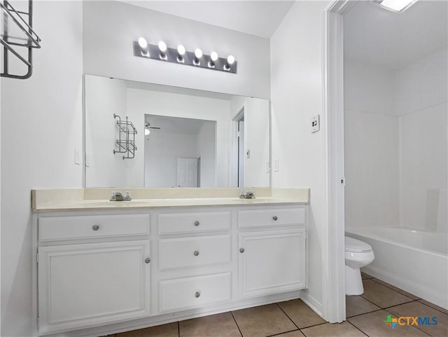 full bathroom with vanity, tile patterned floors, ceiling fan, toilet, and tub / shower combination