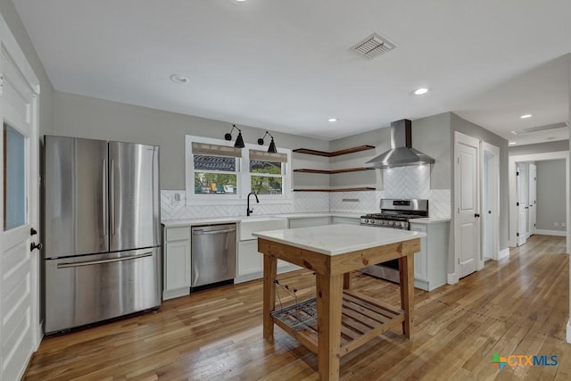 163 S Mesquite Ave, New Braunfels, TX 78130 - kitchen with appliances with stainless steel finishes, wall chimney exhaust hood, open shelves, light countertops, and backsplash