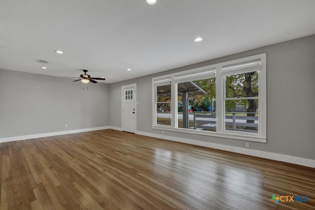 unfurnished living room featuring hardwood / wood-style floors and ceiling fan