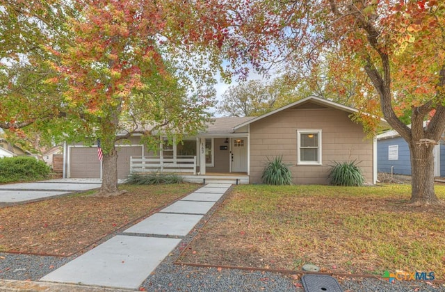 163 S Mesquite Ave, New Braunfels, TX 78130 - ranch-style house with a porch, driveway, a front lawn, and a garage