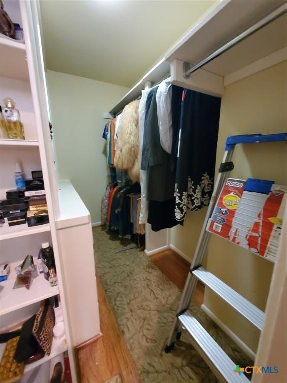 313 N Church, Goliad, TX 77963 - spacious closet featuring wood finished floors