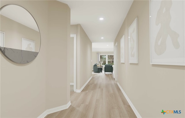 corridor with light hardwood / wood-style floors