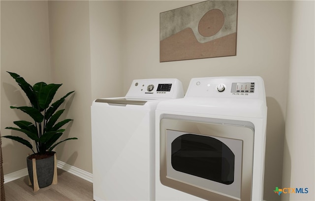 laundry area with wood-type flooring and washer and clothes dryer