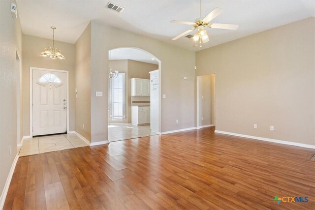 4103 Barrington Trl, Killeen, TX 76549 - foyer featuring arched walkways, light wood-style flooring, a ceiling fan, and a chandelier