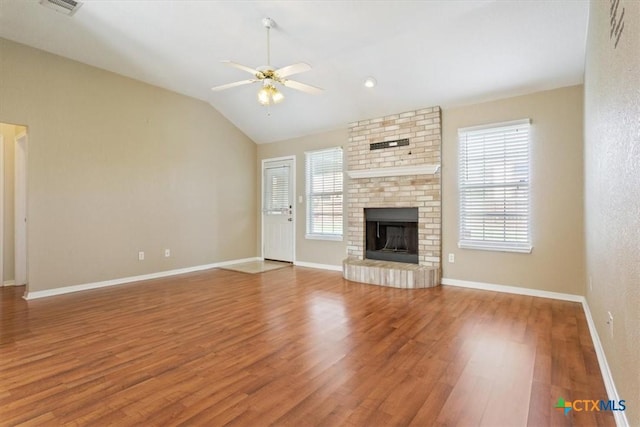 4103 Barrington Trl, Killeen, TX 76549 - unfurnished living room with ceiling fan, wood finished floors, lofted ceiling, and a brick fireplace