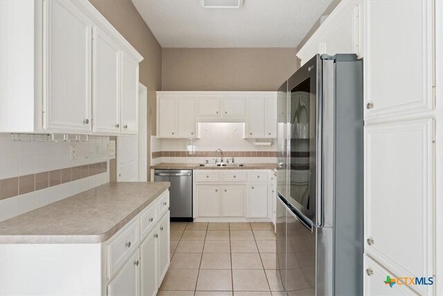 4103 Barrington Trl, Killeen, TX 76549 - kitchen featuring stainless steel appliances, backsplash, white cabinets, and light countertops