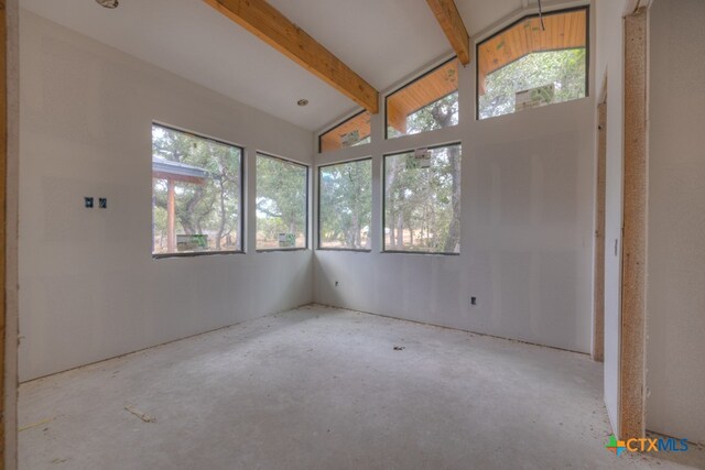 interior space featuring vaulted ceiling with beams