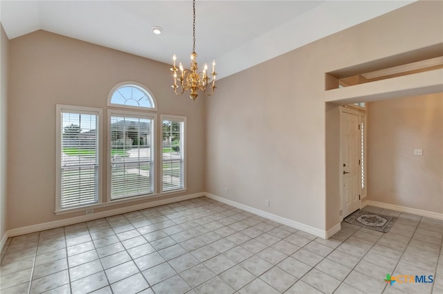 tiled empty room with lofted ceiling and an inviting chandelier