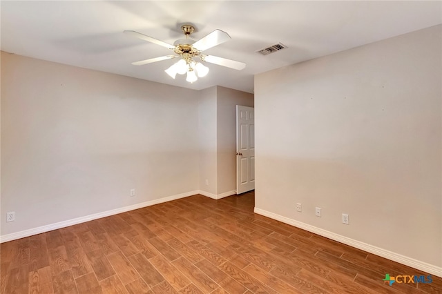 empty room with hardwood / wood-style floors and ceiling fan