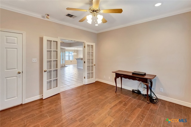 interior space with french doors, hardwood / wood-style flooring, ceiling fan, and crown molding