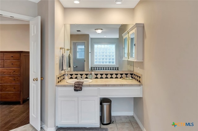 bathroom featuring hardwood / wood-style flooring, vanity, and backsplash