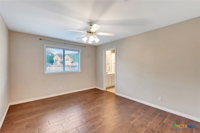 spare room with dark hardwood / wood-style floors and ceiling fan