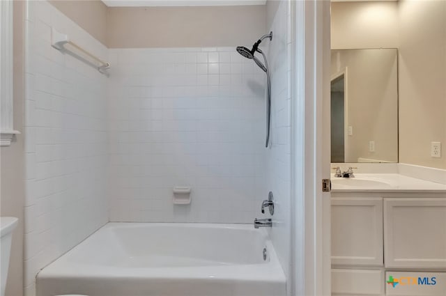 full bathroom featuring toilet, vanity, and tiled shower / bath