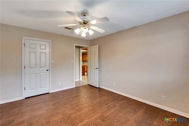 unfurnished bedroom with hardwood / wood-style floors and ceiling fan