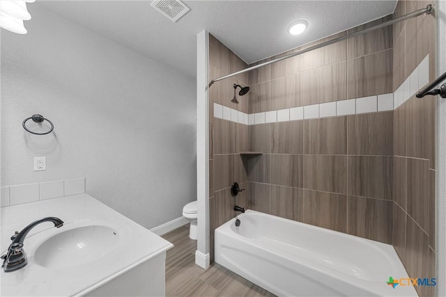 3305 Crystal Ann Dr, Temple, TX 76502 - bathroom featuring shower / tub combination, wood finished floors, vanity, and a textured ceiling