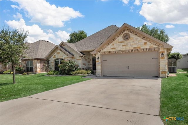 3305 Crystal Ann Dr, Temple, TX 76502 - french country home with stone siding, driveway, a garage, and a front lawn