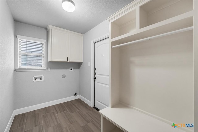 3305 Crystal Ann Dr, Temple, TX 76502 - laundry area with electric dryer hookup, cabinet space, washer hookup, a textured ceiling, and dark wood finished floors