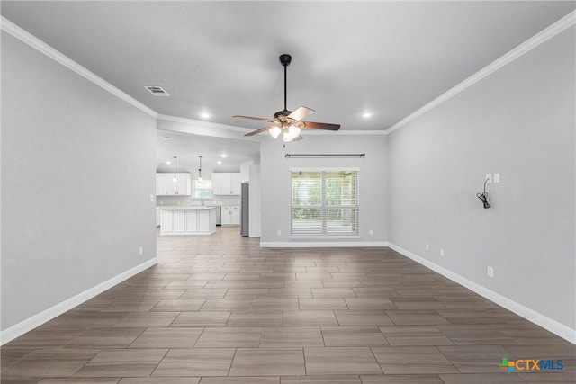 3305 Crystal Ann Dr, Temple, TX 76502 - unfurnished living room featuring a ceiling fan, recessed lighting, crown molding, and wood finished floors