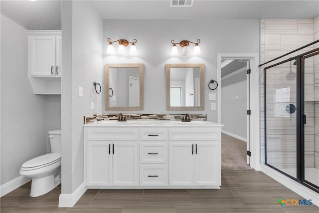 3305 Crystal Ann Dr, Temple, TX 76502 - full bathroom featuring double vanity, wood tiled floors, and a shower stall