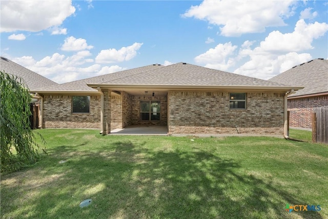 3305 Crystal Ann Dr, Temple, TX 76502 - rear view of property featuring brick siding, roof with shingles, and a patio area