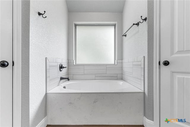 3305 Crystal Ann Dr, Temple, TX 76502 - bathroom featuring a textured wall and a garden tub