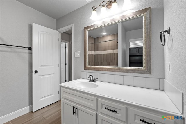 3305 Crystal Ann Dr, Temple, TX 76502 - full bath with vanity, a textured wall, wood finished floors, and a shower with curtain