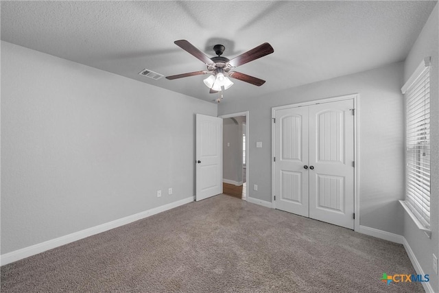 3305 Crystal Ann Dr, Temple, TX 76502 - unfurnished bedroom featuring carpet, a closet, a textured ceiling, and ceiling fan