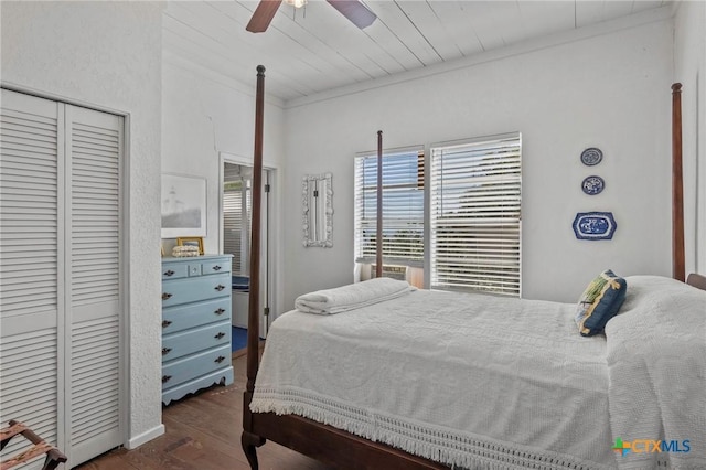 bedroom featuring ceiling fan, a closet, wooden ceiling, and wood finished floors