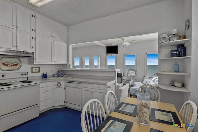 kitchen featuring white cabinets, under cabinet range hood, white appliances, and ceiling fan