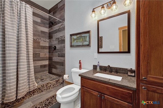 bathroom featuring walk in shower, vanity, toilet, and wood-type flooring