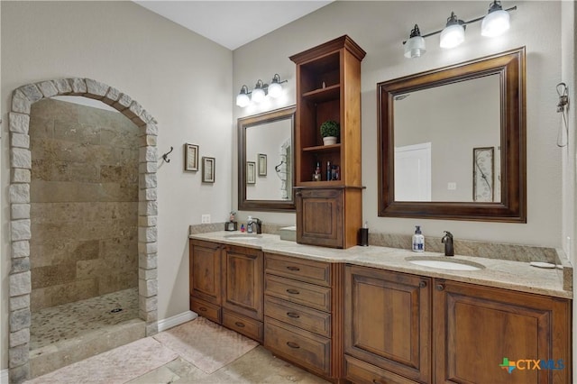 2611 Westview Dr, Canyon Lake, TX 78133 - bathroom featuring a tile shower and double vanity