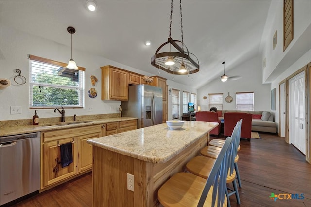 2611 Westview Dr, Canyon Lake, TX 78133 - kitchen with stainless steel appliances, a sink, a kitchen island, open floor plan, and light stone countertops