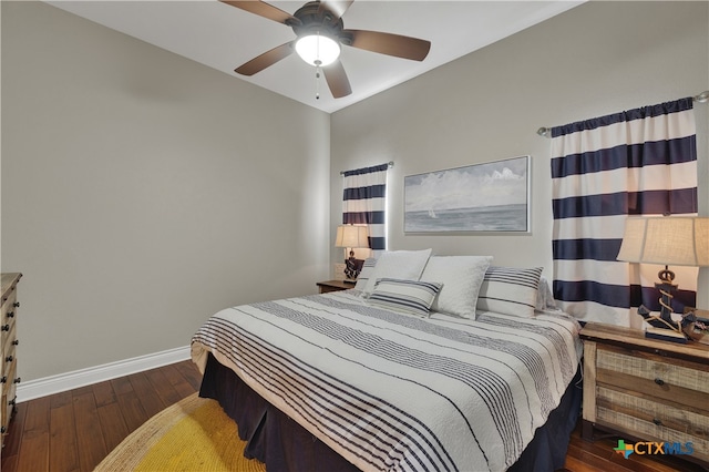 bedroom with ceiling fan and dark hardwood / wood-style flooring