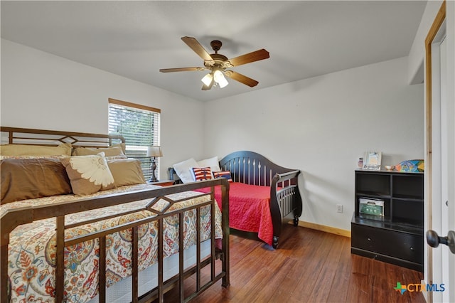 bedroom featuring ceiling fan and dark hardwood / wood-style floors