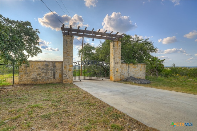 view of gate featuring a yard