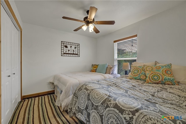 bedroom featuring ceiling fan and a closet