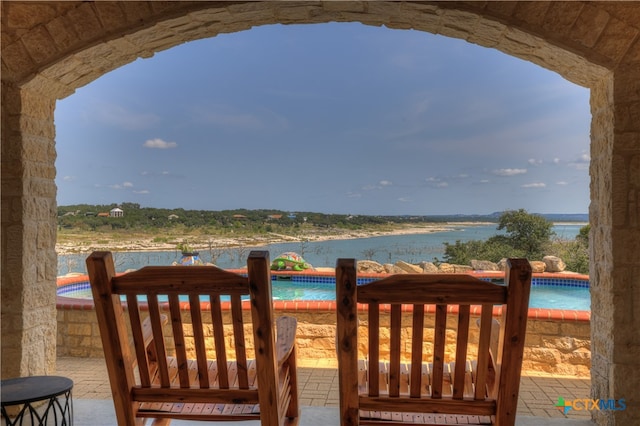 exterior space with a water view and a pool