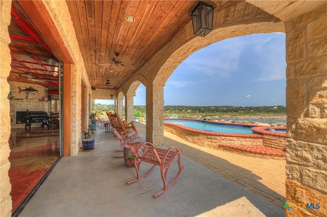 2611 Westview Dr, Canyon Lake, TX 78133 - view of patio / terrace with an outdoor pool, an in-ground hot tub, a water view, and ceiling fan