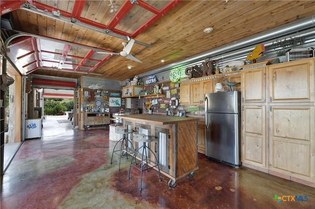 2611 Westview Dr, Canyon Lake, TX 78133 - kitchen featuring freestanding refrigerator, finished concrete flooring, open shelves, a breakfast bar area, and ceiling fan