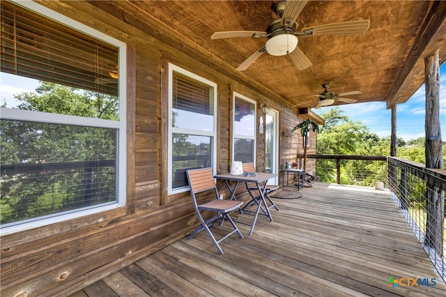 wooden terrace featuring ceiling fan