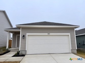 single story home with concrete driveway and a garage