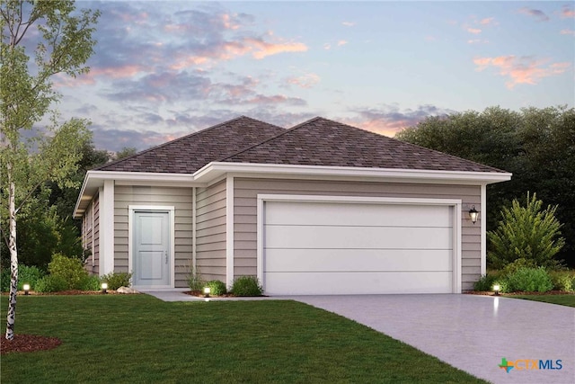 view of front of house with a garage and a lawn